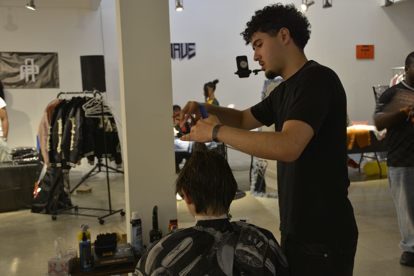 BKFADES barber cutting a client's hair in the studio